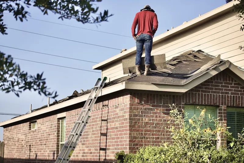 Professional roofer working on a residential roof in Hunters Ridge